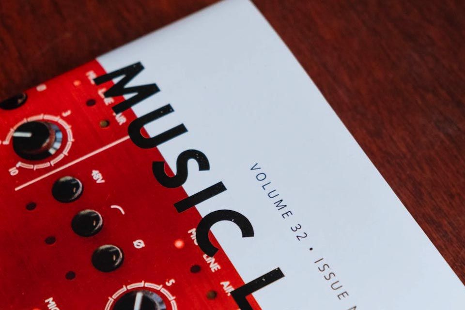 The corner of a magazine showing part of the title "Music Loves" and an image of dials 